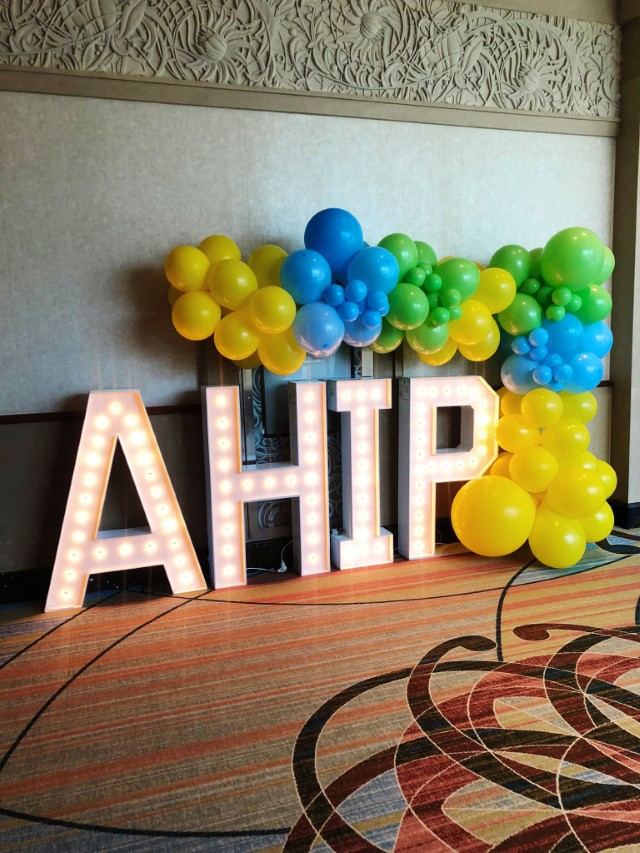 Bowmanville balloon garland framing marquee letters