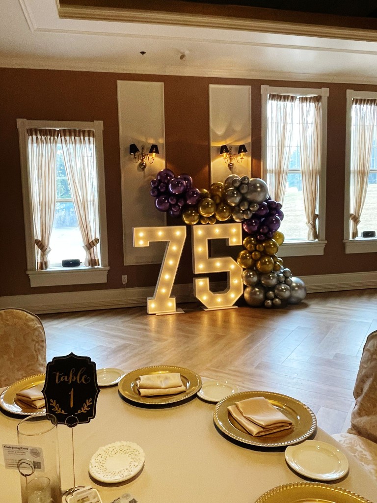 Marquee numbers in St. Thomas, that display the number 75 framed by balloon decor