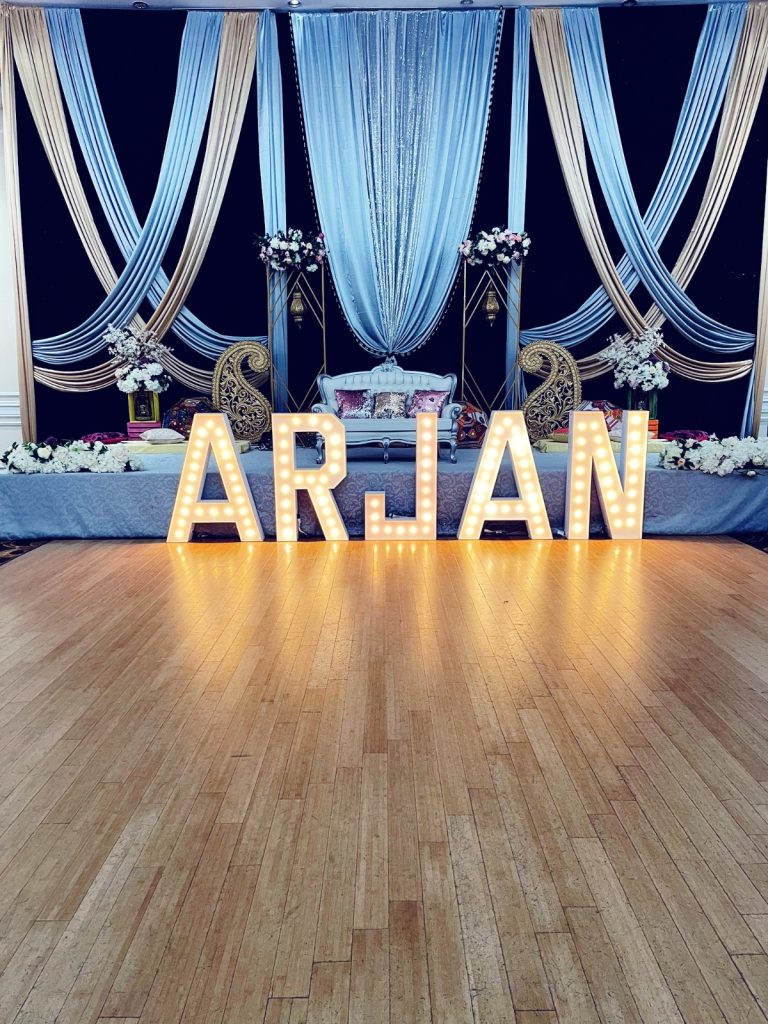 Woodstock marquee letters for rent that spell out Arjan in front of event decor