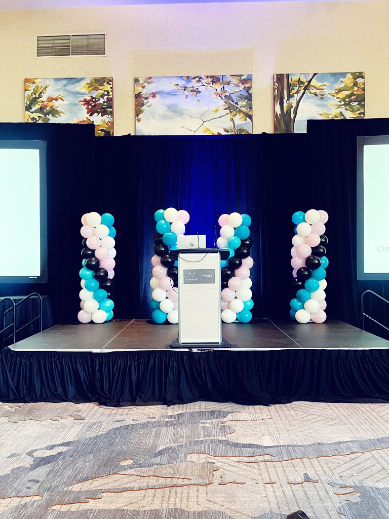 Belleville balloon pillars and blue drapes