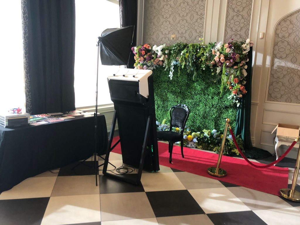 Mirror photo booth in Bowmanville with a red carpet rental, stanchions and flower wall