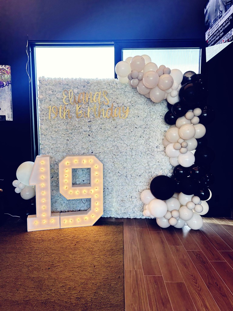 Peterborough flower wall with balloon arch and marquee numbers. Birthday decor in Peterborough